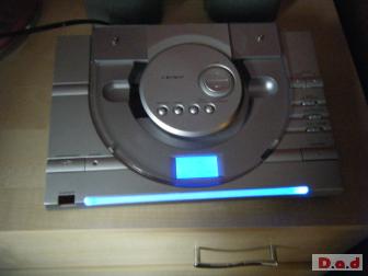 crown cd player and speakers. silver with blue light.